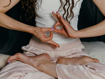 Close-up of hands in a meditative yoga mudra.